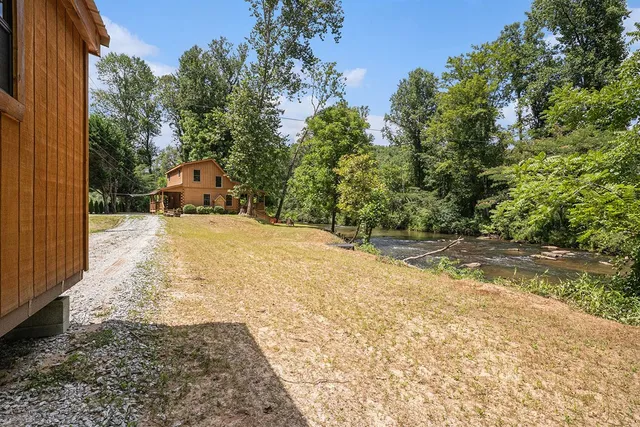 a view of a yard with wooden fence
