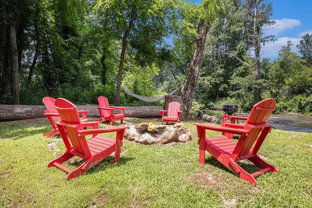 a backyard of a house with table and chairs