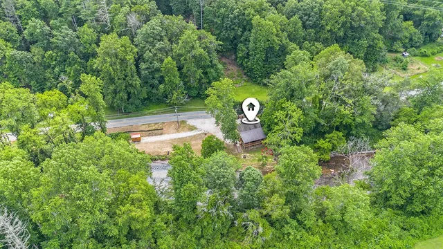 a view of a house with a yard and sitting area
