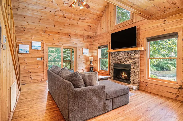 a living room with furniture a flat screen tv and a fireplace