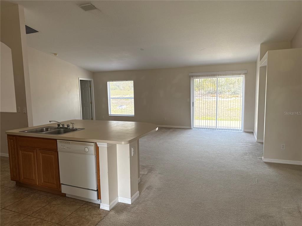 4725 Southwest 100th Street Ocala, FL 34476 - Photo 12 of 24 a kitchen with a stove and a refrigerator