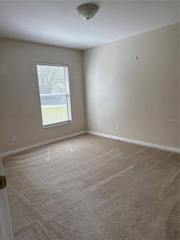 4725 Southwest 100th Street Ocala, FL 34476 - Photo 14 of 24 an empty room with a window