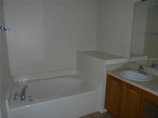 a bath tub sitting next to a white sink