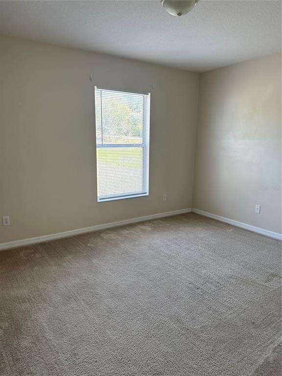 4725 Southwest 100th Street Ocala, FL 34476 - Photo 15 of 24 an empty room with a window