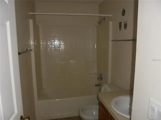 a bathroom with a shower and a toilet