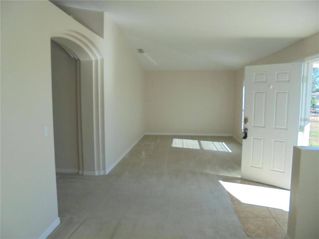 4725 Southwest 100th Street Ocala, FL 34476 - Photo 3 of 24 an empty room with a empty space
