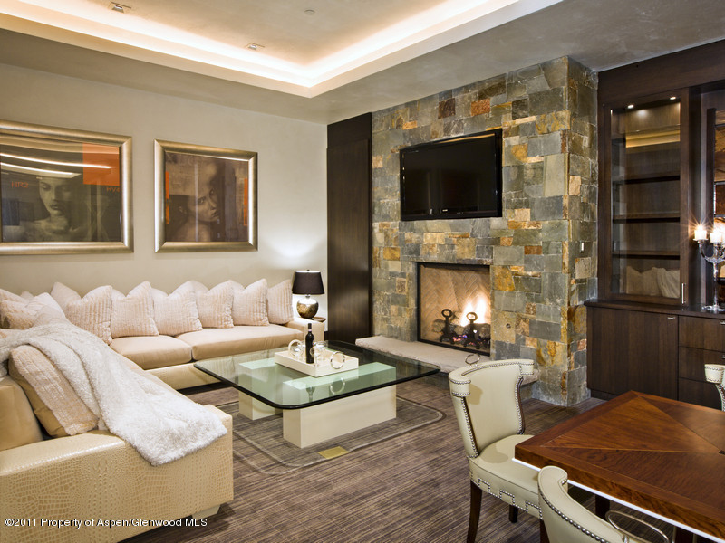 675 Aspen Alps Road South Aspen, CO 81611 - Photo 17 of 37 a living room with furniture a flat screen tv and a fireplace