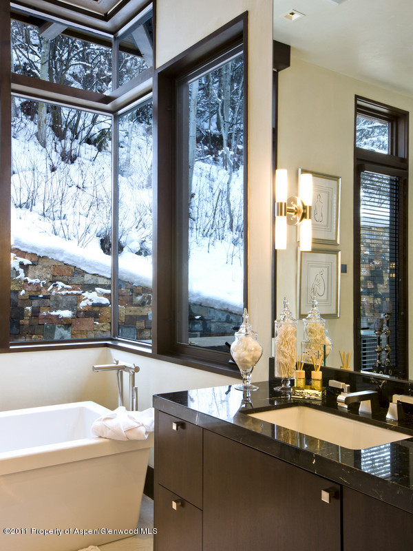 675 Aspen Alps Road South Aspen, CO 81611 - Photo 24 of 37 a bathroom with a granite countertop sink and a large mirror