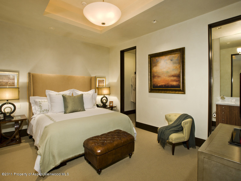 675 Aspen Alps Road South Aspen, CO 81611 - Photo 27 of 37 a bedroom with bed and a chandelier