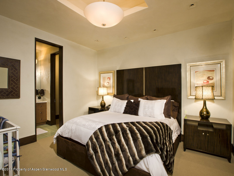 675 Aspen Alps Road South Aspen, CO 81611 - Photo 29 of 37 a bedroom with a bed and a chandelier