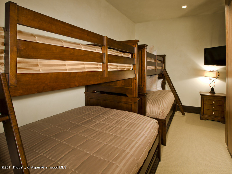 675 Aspen Alps Road South Aspen, CO 81611 - Photo 30 of 37 a bedroom with a bed and flat screen tv