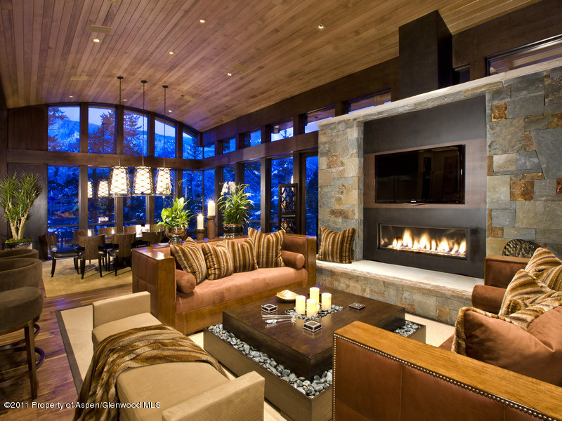 675 Aspen Alps Road South Aspen, CO 81611 - Photo 8 of 37 a living room with furniture a floor to ceiling window and a flat screen tv