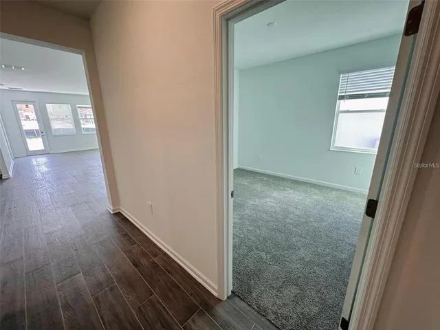 a view of hallway with wooden floor