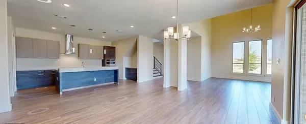 a large kitchen with hardwood floor a sink and stainless steel appliances