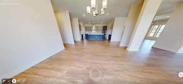 a view of a hallway with furniture and a chandelier