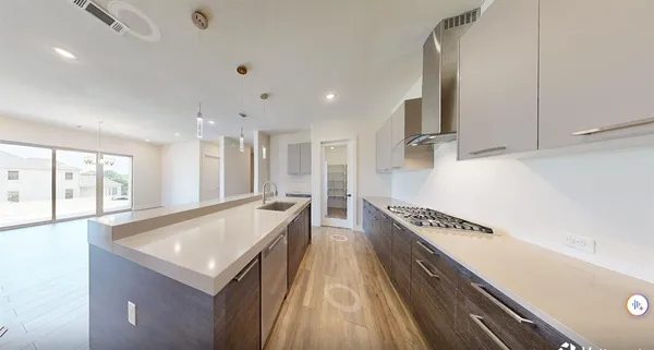 a large white kitchen with a large window