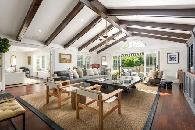 a living room with lots of furniture and a large window