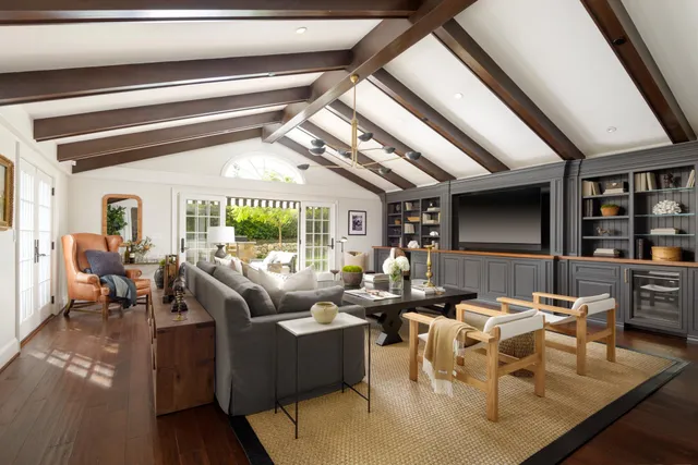 a living room with fireplace furniture and a large window