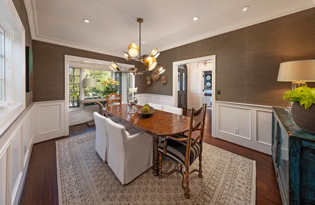 a living room with furniture a window and a chandelier