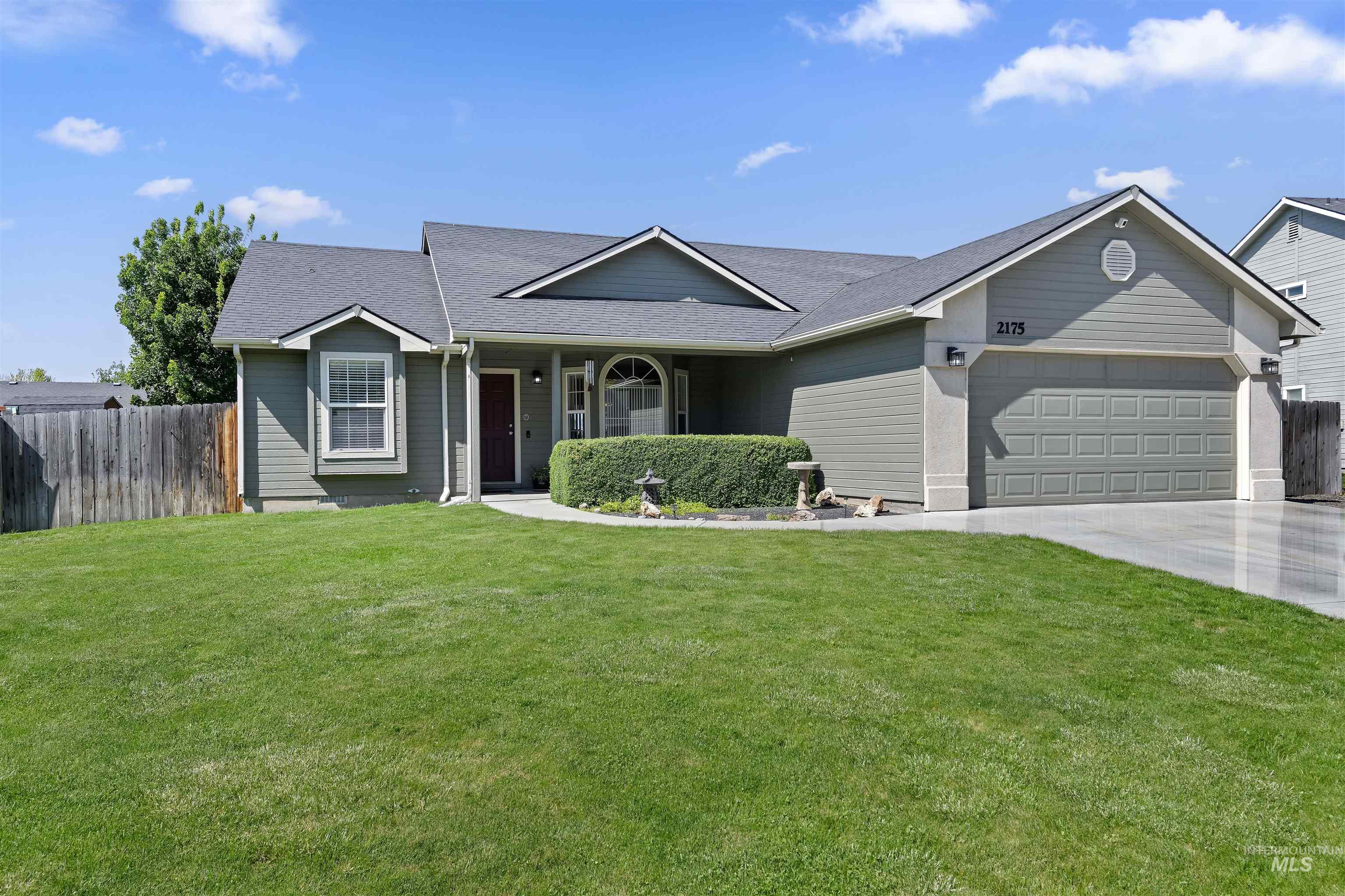 Single-story residence featuring grey siding and a dark grey shingle roof