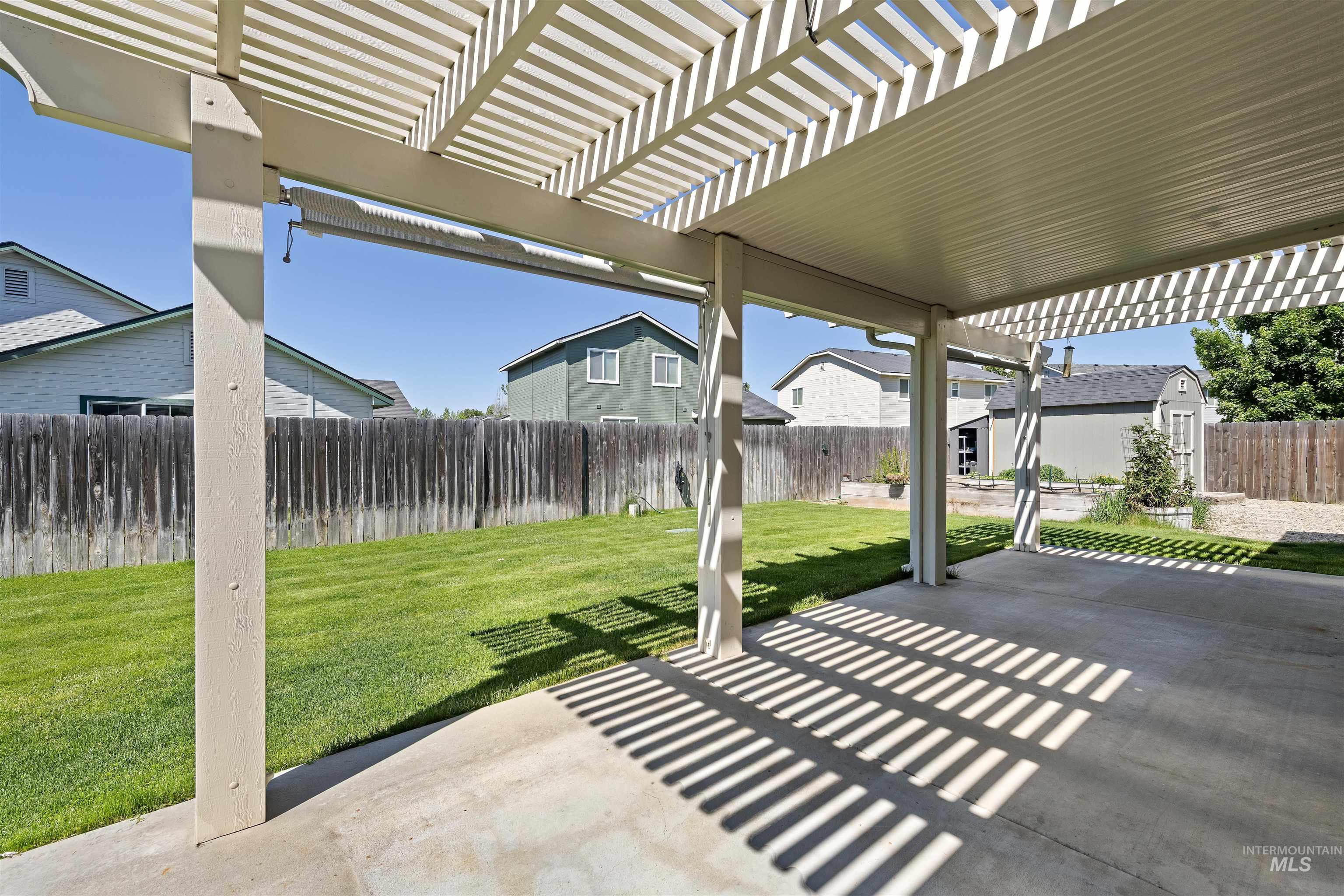 2175 North CapeCod Way Meridian, ID 83646 - Photo 20 of 23 Expansive concrete patio featuring a partial slatted pergola and a solid roof covering