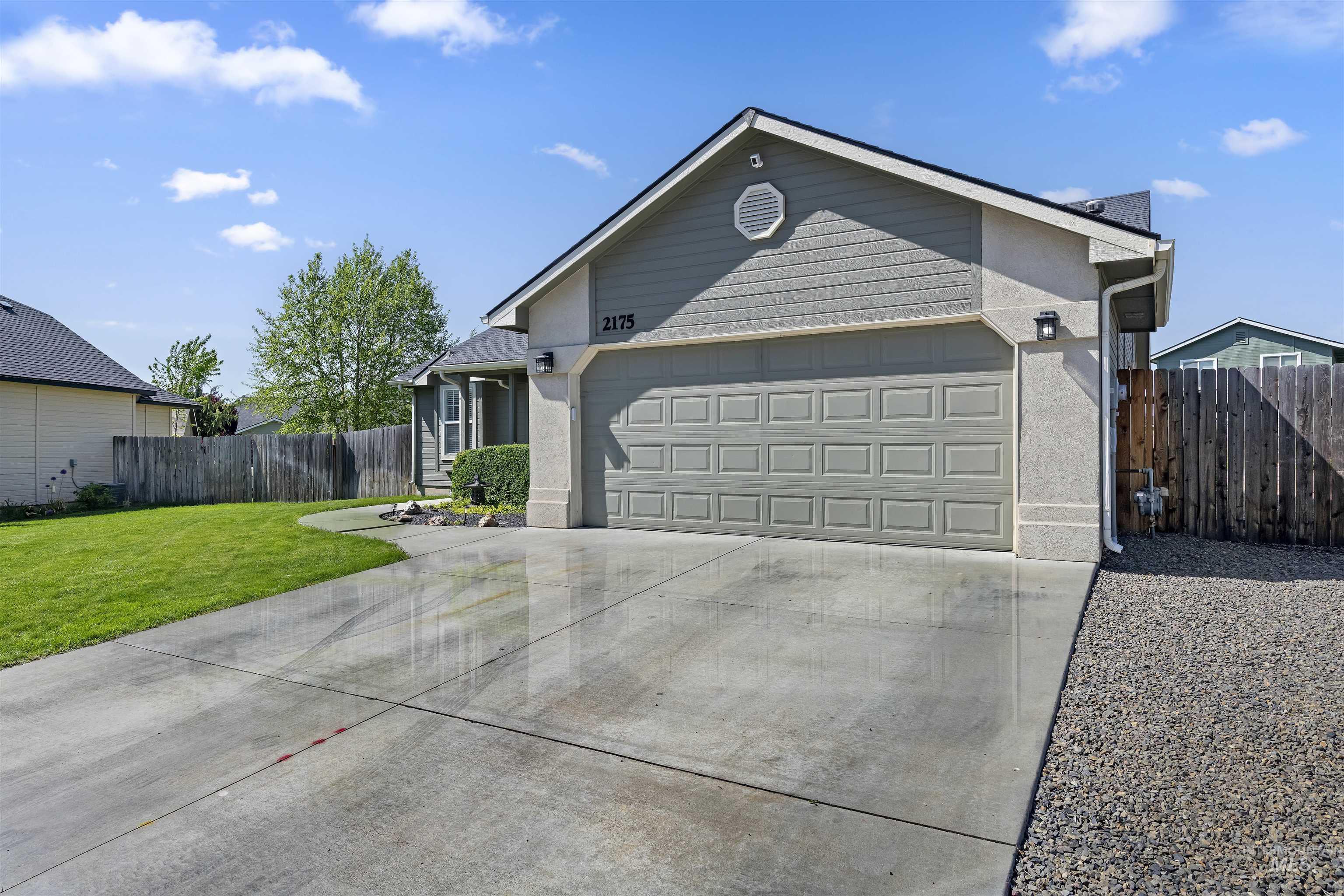 2175 North CapeCod Way Meridian, ID 83646 - Photo 3 of 23 Contemporary residence featuring a two-car garage, concrete driveway, and a combination of siding and stucco exterior