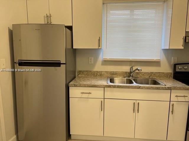 2139 Southwest 5th Street Miami, FL 33135 - Photo 14 of 19 a white refrigerator freezer sitting in a kitchen