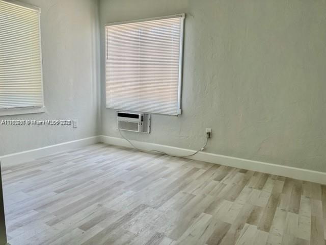 2139 Southwest 5th Street Miami, FL 33135 - Photo 18 of 19 an empty room with wooden floor and windows