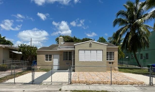 2139 Southwest 5th Street Miami, FL 33135 - Photo 2 of 19 a front view of a house with a yard and garage