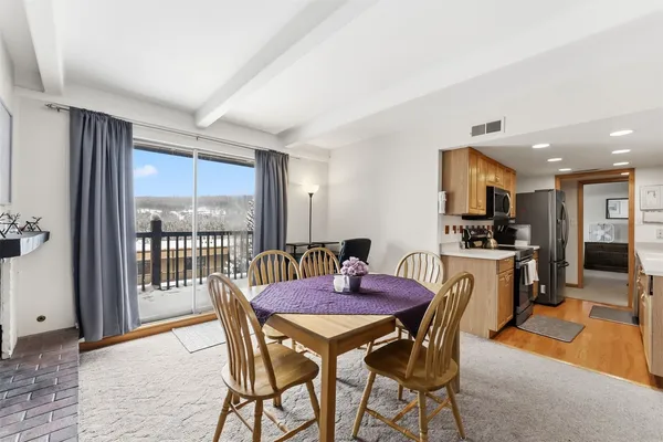 a view of a dining room with furniture and a window