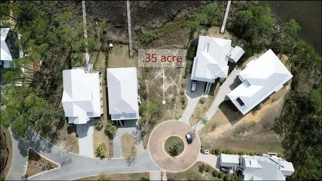 an aerial view of a house with outdoor space and swimming pool