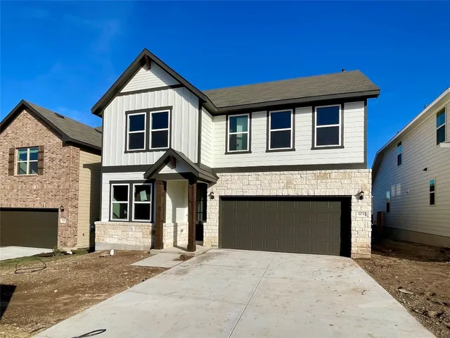 a front view of a house with a garage