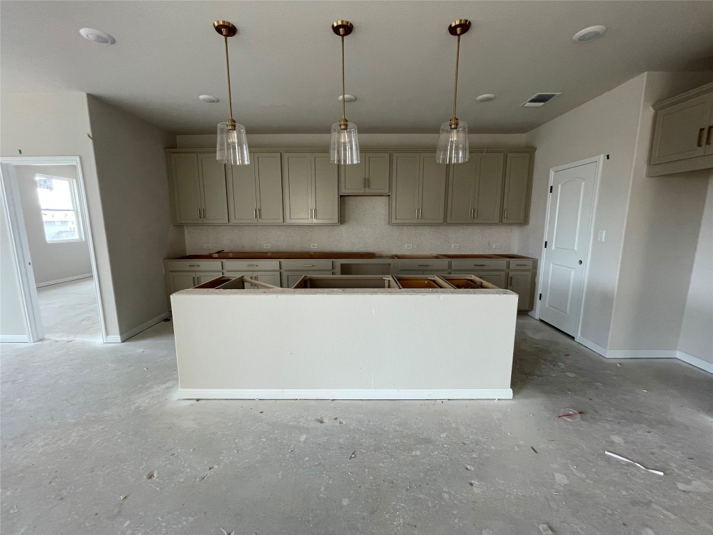604 Palo Brea Loop Hutto, TX 78634 - Photo 12 of 36 a view of a kitchen with stainless steel appliances granite countertop cabinets and a wooden floor
