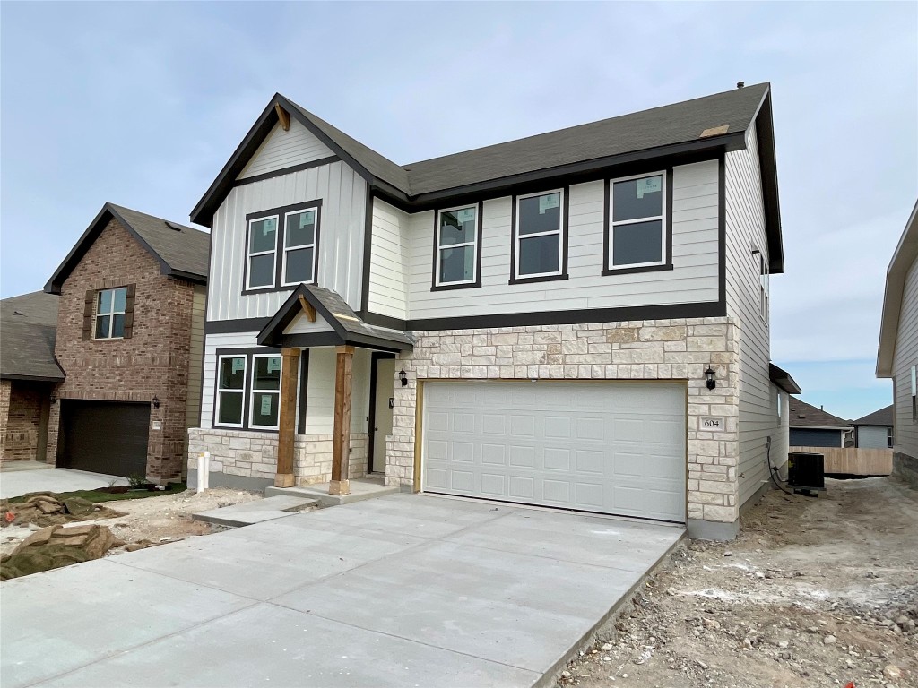 604 Palo Brea Loop Hutto, TX 78634 - Photo 2 of 36 a front view of a house with a yard and garage
