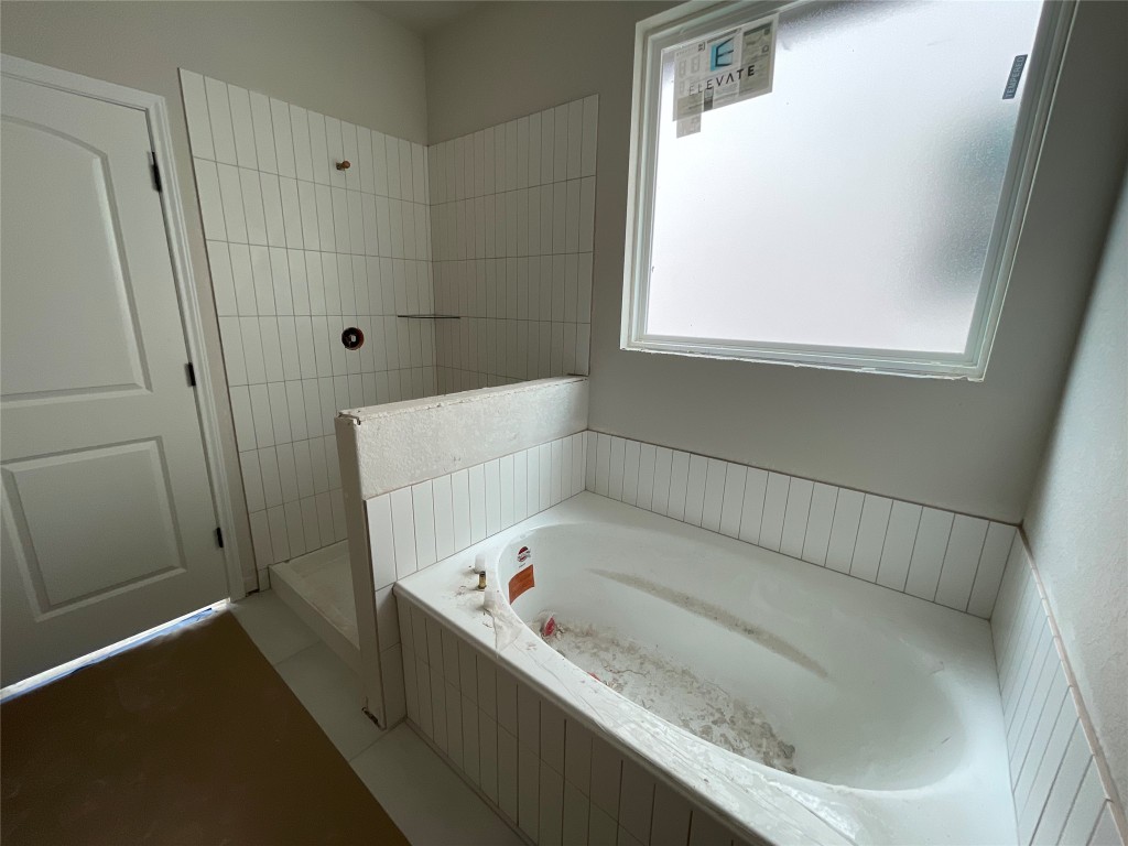 604 Palo Brea Loop Hutto, TX 78634 - Photo 22 of 36 a bathroom with a tub and a window
