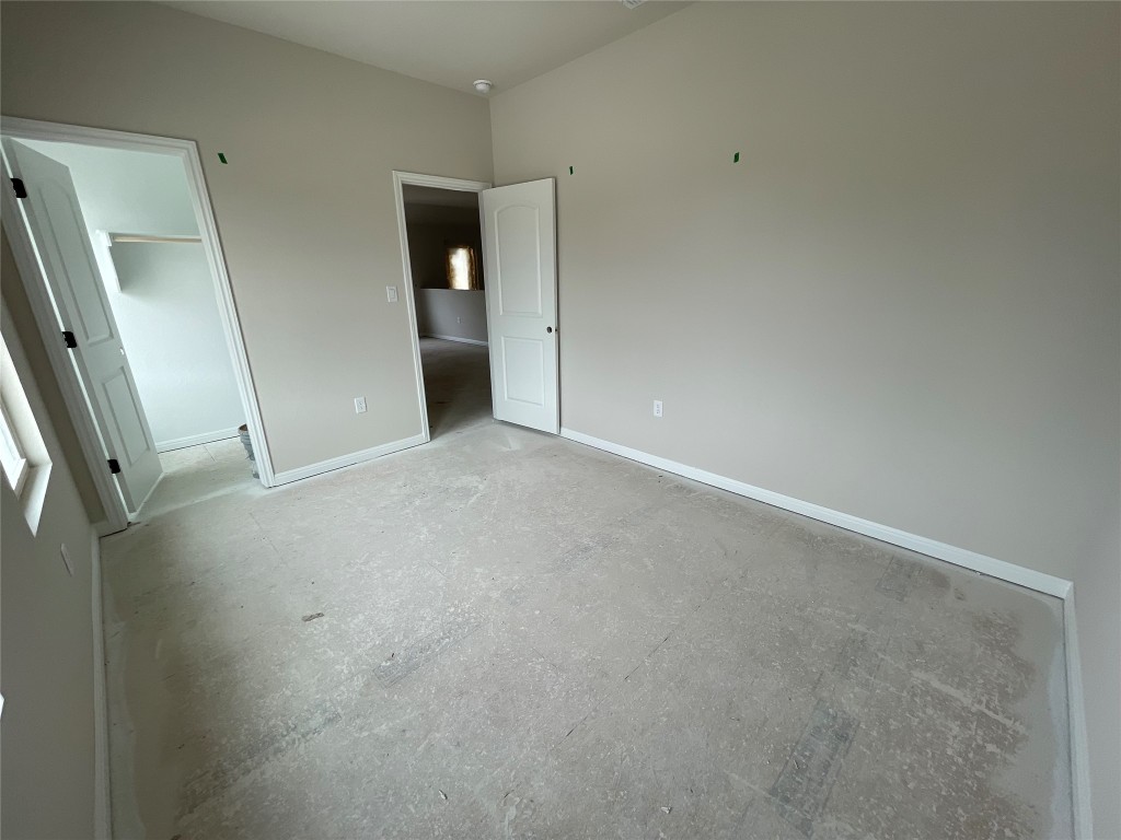 604 Palo Brea Loop Hutto, TX 78634 - Photo 29 of 36 an empty room with an entrance to other room