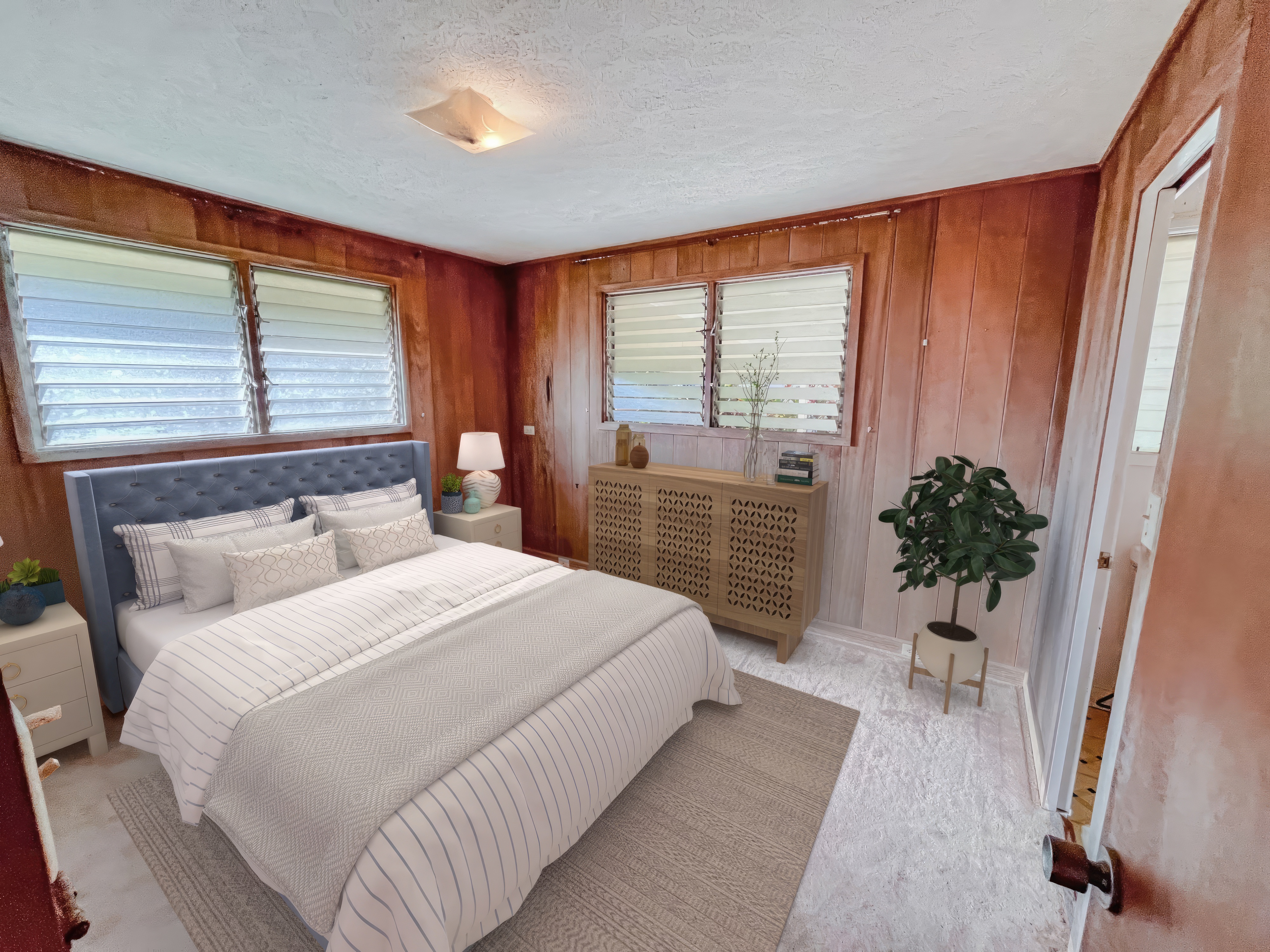 106 Laula Road Hilo, HI 96720 - Photo 14 of 30 a bedroom with a large bed and a potted plant