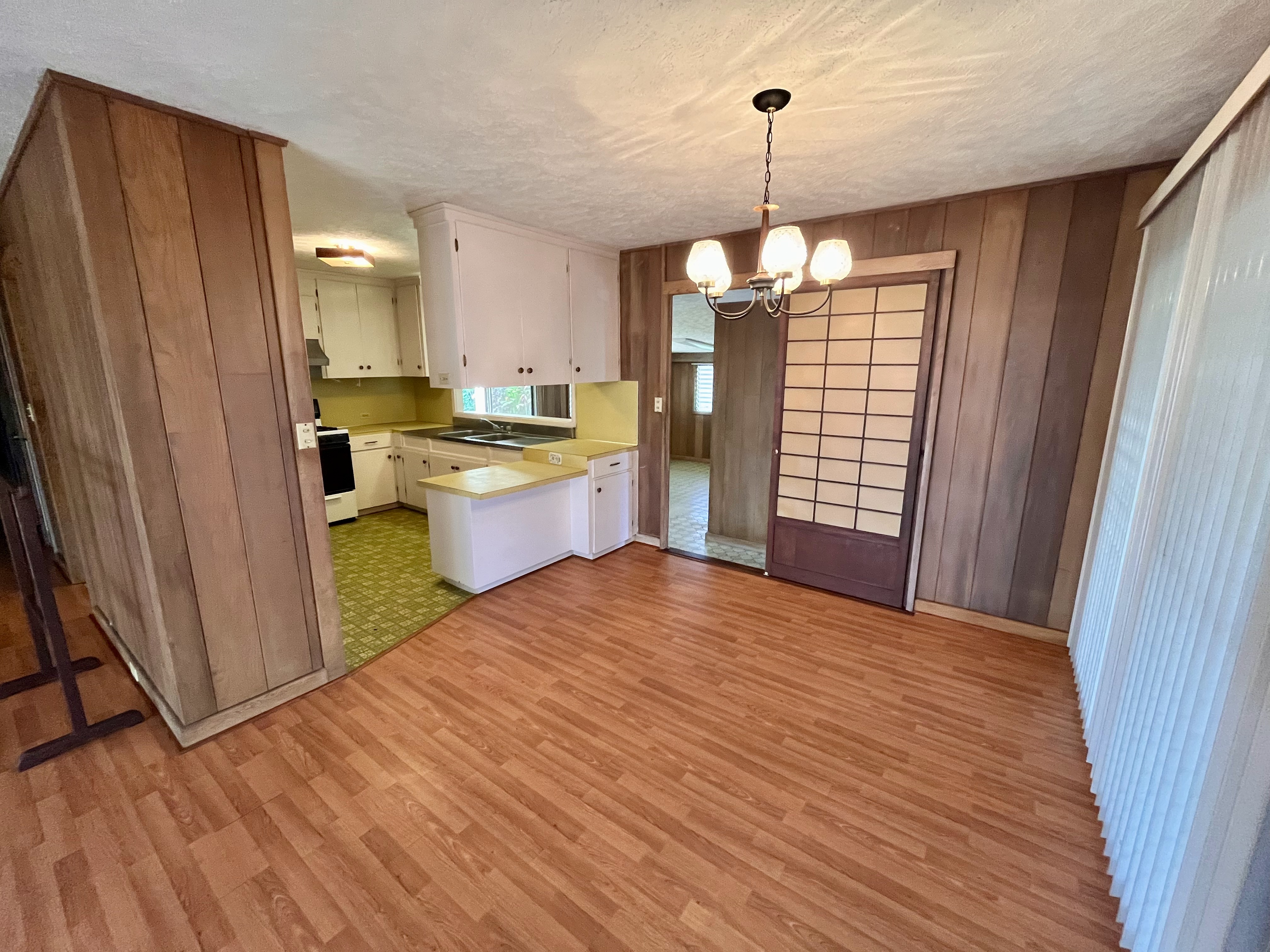 106 Laula Road Hilo, HI 96720 - Photo 9 of 30 a view of a kitchen with granite countertop wooden floor and a refrigerator