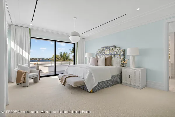 a view of a white building with a yard