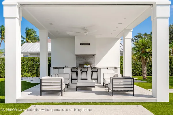 a bathroom with a granite countertop sink and a toilet