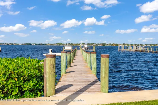 a living room with furniture and potted plants