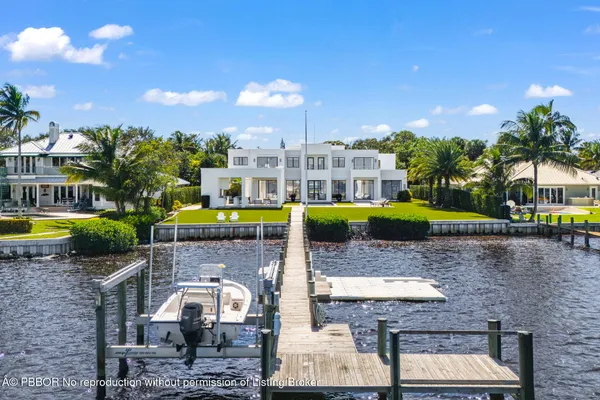 a large white kitchen with a large window