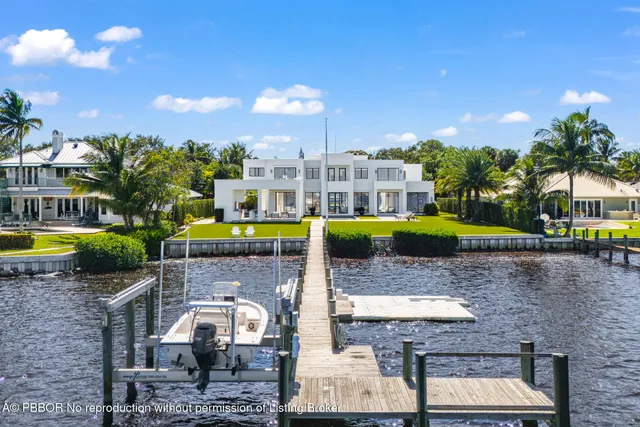 a large white kitchen with a large window