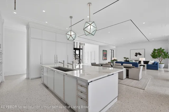 a spacious bedroom with a bed and a chandelier