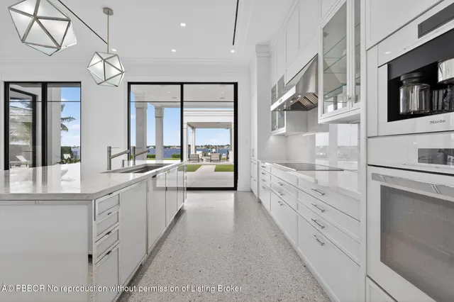a large white bathroom with a double vanity sink large mirror and a bathtub