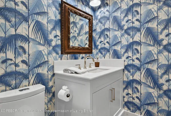 a bathroom with a double vanity sink mirror and toilet
