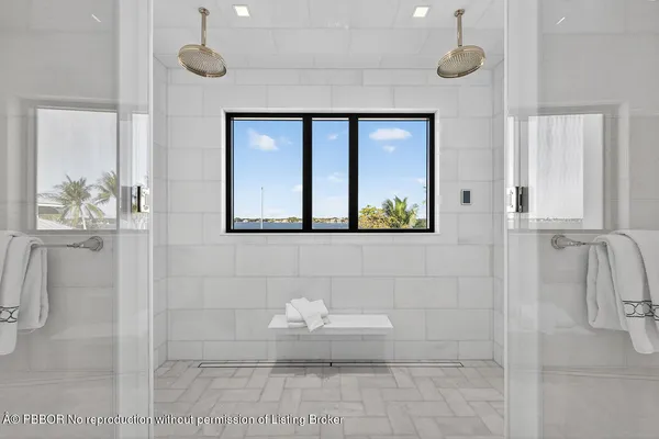 a bathroom with a shower sink and mirror