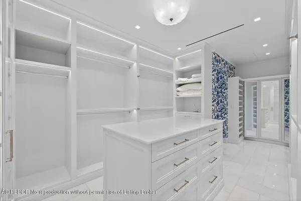 a view of a patio with couches potted plants and a floor to ceiling window