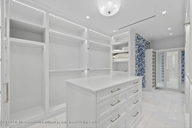 a view of a patio with couches potted plants and a floor to ceiling window