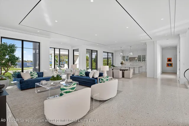 a living room with a large window and furniture